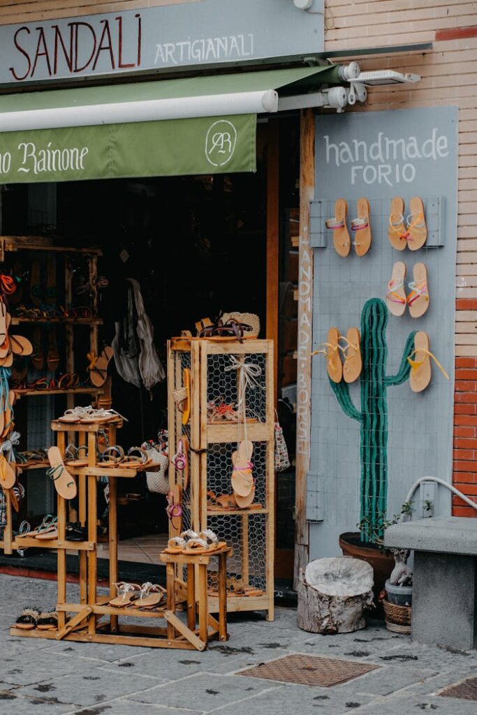 Outdoor display of handmade sandals at a shop in Forio, Italy.